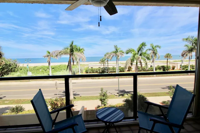 a bedroom with a bed and a lamp next to a window