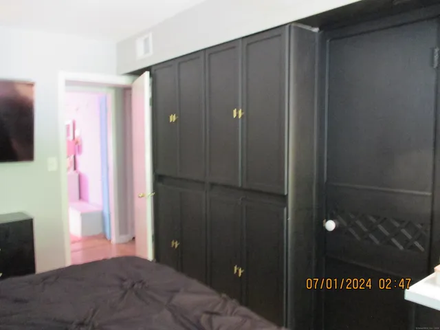 a bedroom with a bed and a flat tv screen