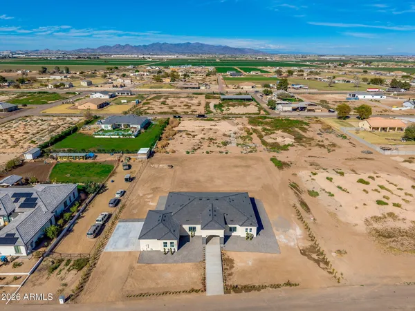 a kitchen with kitchen island granite countertop a stove a sink and a refrigerator