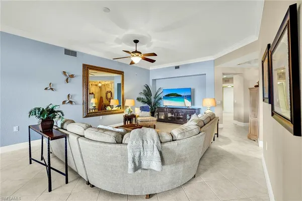 a living room with furniture and a chandelier