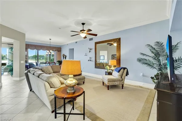 a living room with furniture and a chandelier