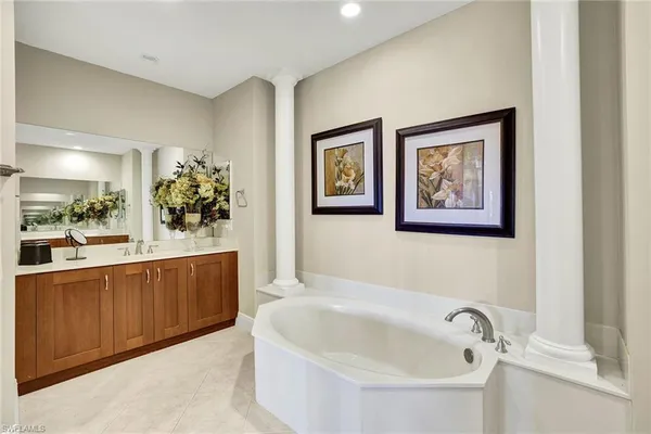 a bathroom with a bathtub and mirror