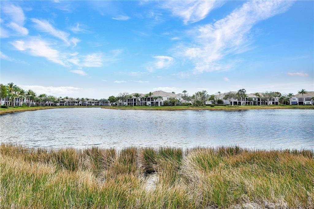 9234 Tesoro Lane, Unit 101 Naples, FL 34114 - Photo 2 of 25 a view of a lake with a city view