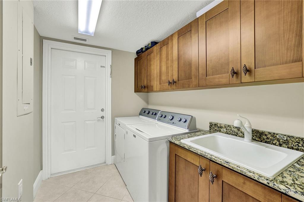 9234 Tesoro Lane, Unit 101 Naples, FL 34114 - Photo 23 of 25 a bathroom with a sink and a mirror