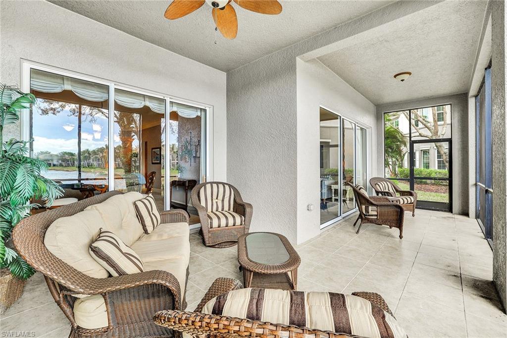 9234 Tesoro Lane, Unit 101 Naples, FL 34114 - Photo 24 of 25 a living room with furniture and a large window