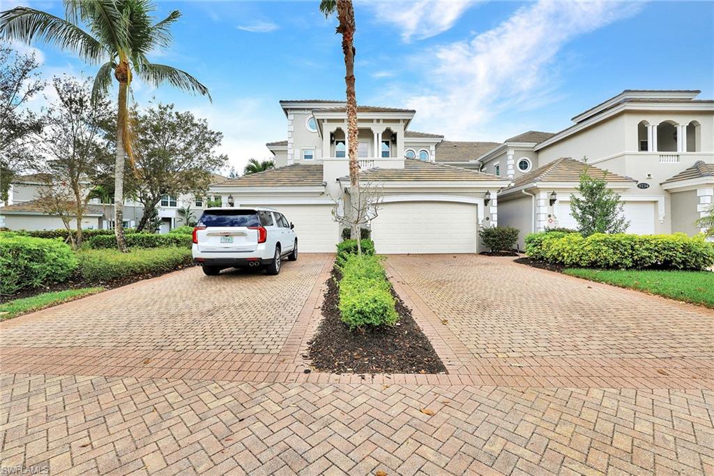 9234 Tesoro Lane, Unit 101 Naples, FL 34114 - Photo 25 of 25 a front view of a house with a garden and trees