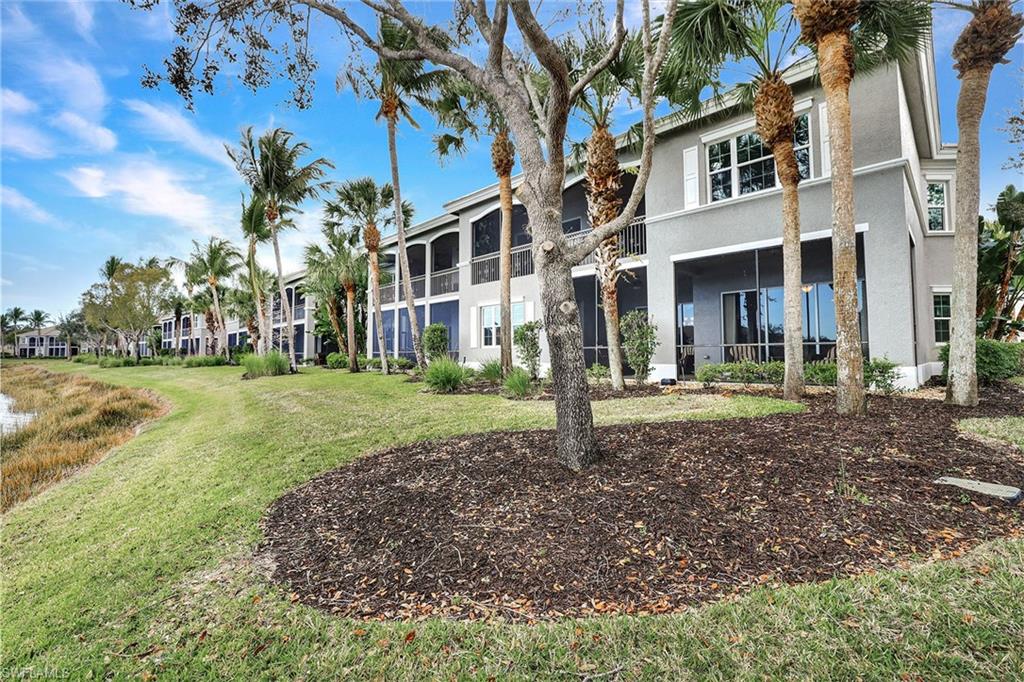 9234 Tesoro Lane, Unit 101 Naples, FL 34114 - Photo 3 of 25 a view of a house with a yard