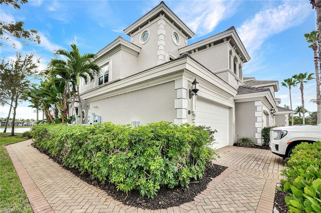 9234 Tesoro Lane, Unit 101 Naples, FL 34114 - Photo 4 of 25 a front view of a house with garden