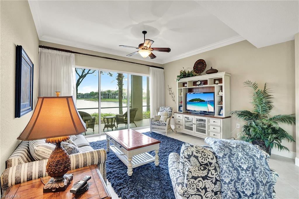 9234 Tesoro Lane, Unit 101 Naples, FL 34114 - Photo 6 of 25 a living room with furniture a flat screen tv and a large window