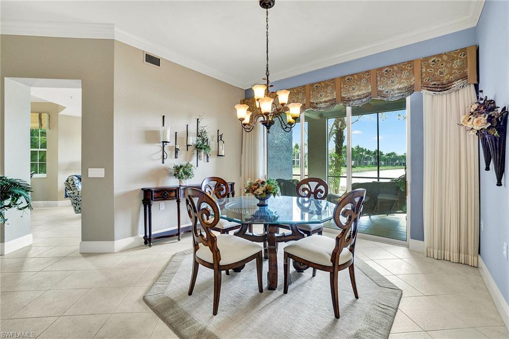 9234 Tesoro Lane, Unit 101 Naples, FL 34114 - Photo 8 of 25 a dining room with furniture a chandelier and window