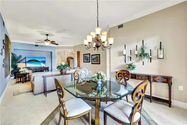 a dining room with furniture and chandelier