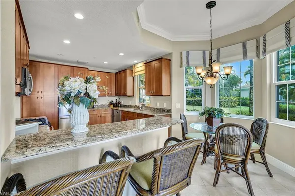 a dining table seating space with furniture and floor to ceiling window