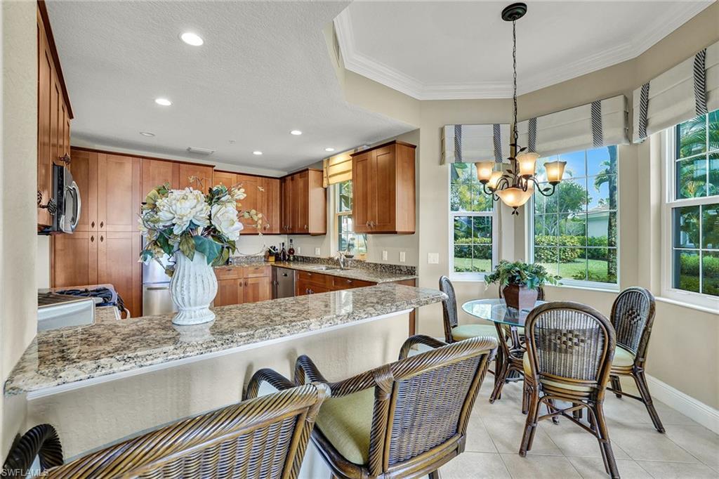 9234 Tesoro Lane, Unit 101 Naples, FL 34114 - Photo 10 of 25 a dining table seating space with furniture and floor to ceiling window