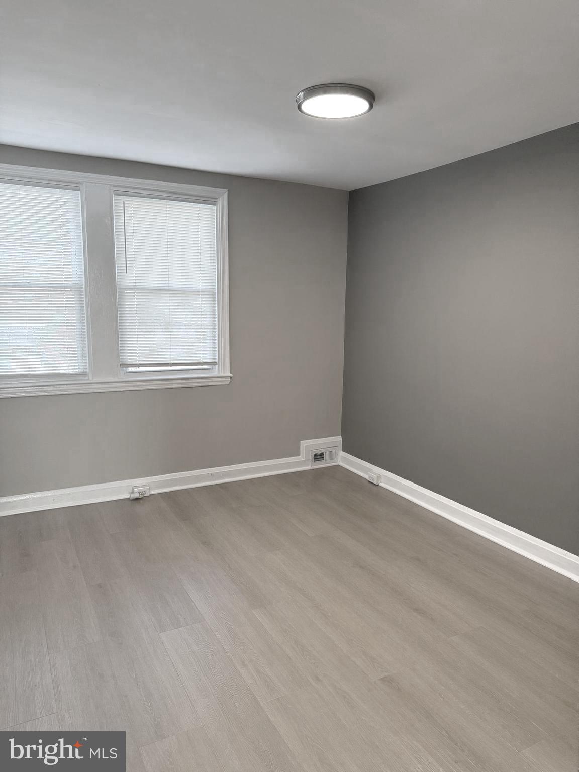 815 East Cold Spring Lane Baltimore, MD 21212 - Photo 18 of 43 an empty room with wooden floor and windows