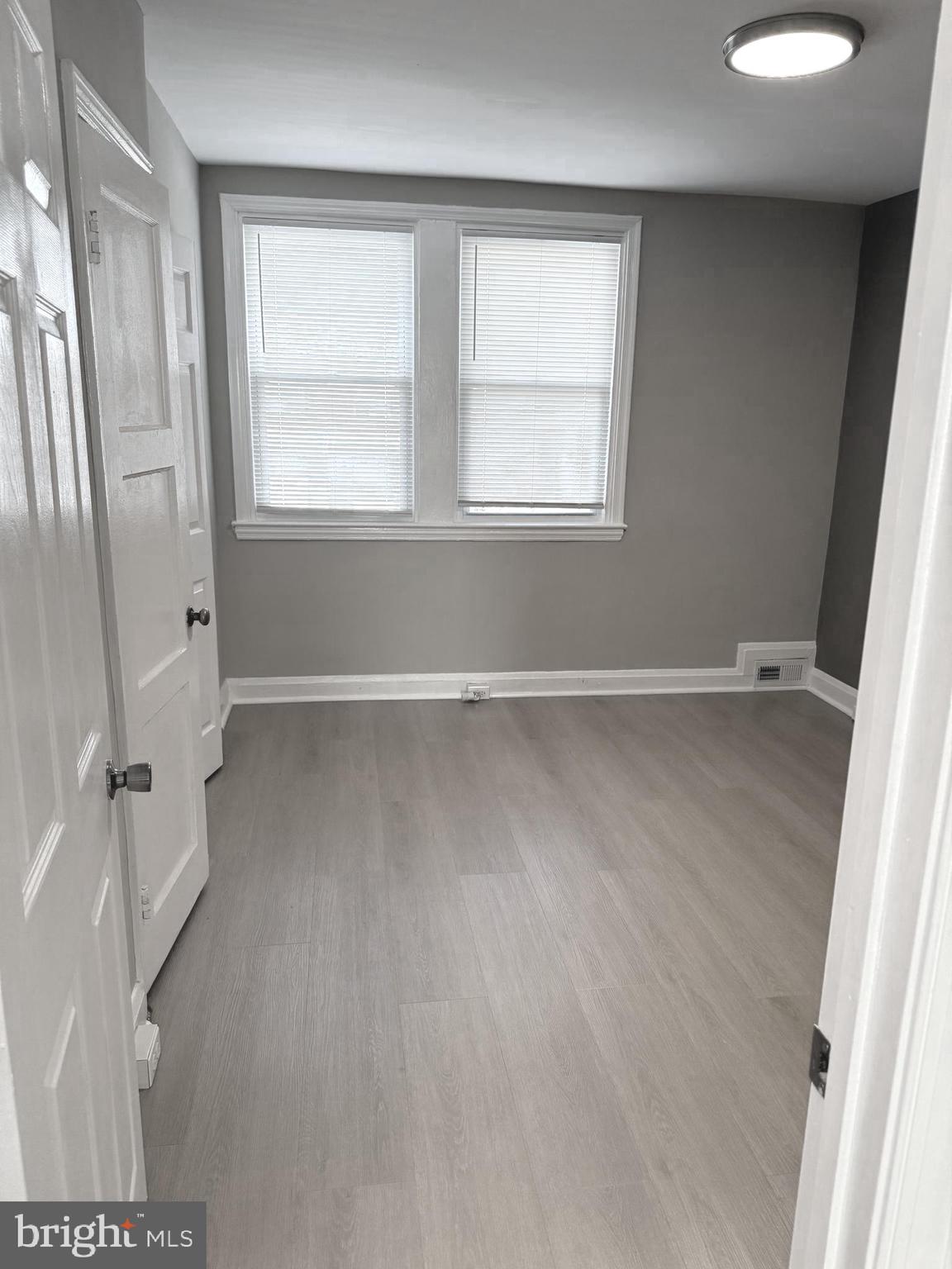 815 East Cold Spring Lane Baltimore, MD 21212 - Photo 20 of 43 an empty room with wooden floor and windows