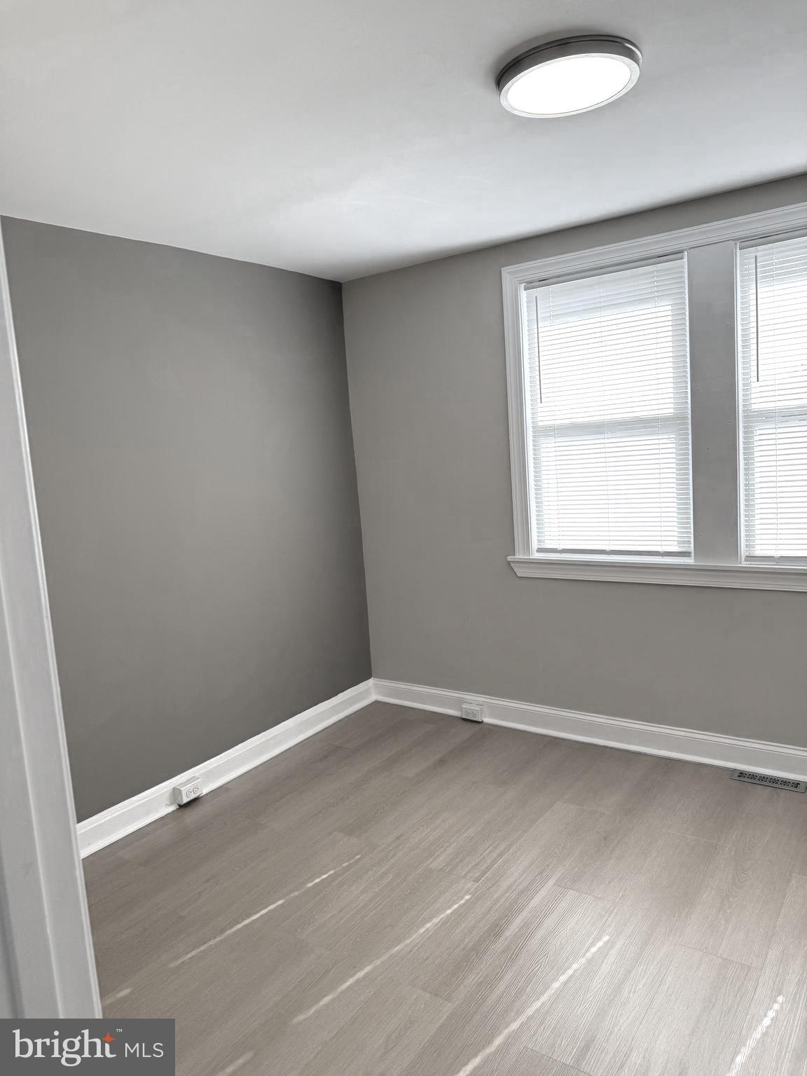 815 East Cold Spring Lane Baltimore, MD 21212 - Photo 21 of 43 an empty room with wooden floor and windows