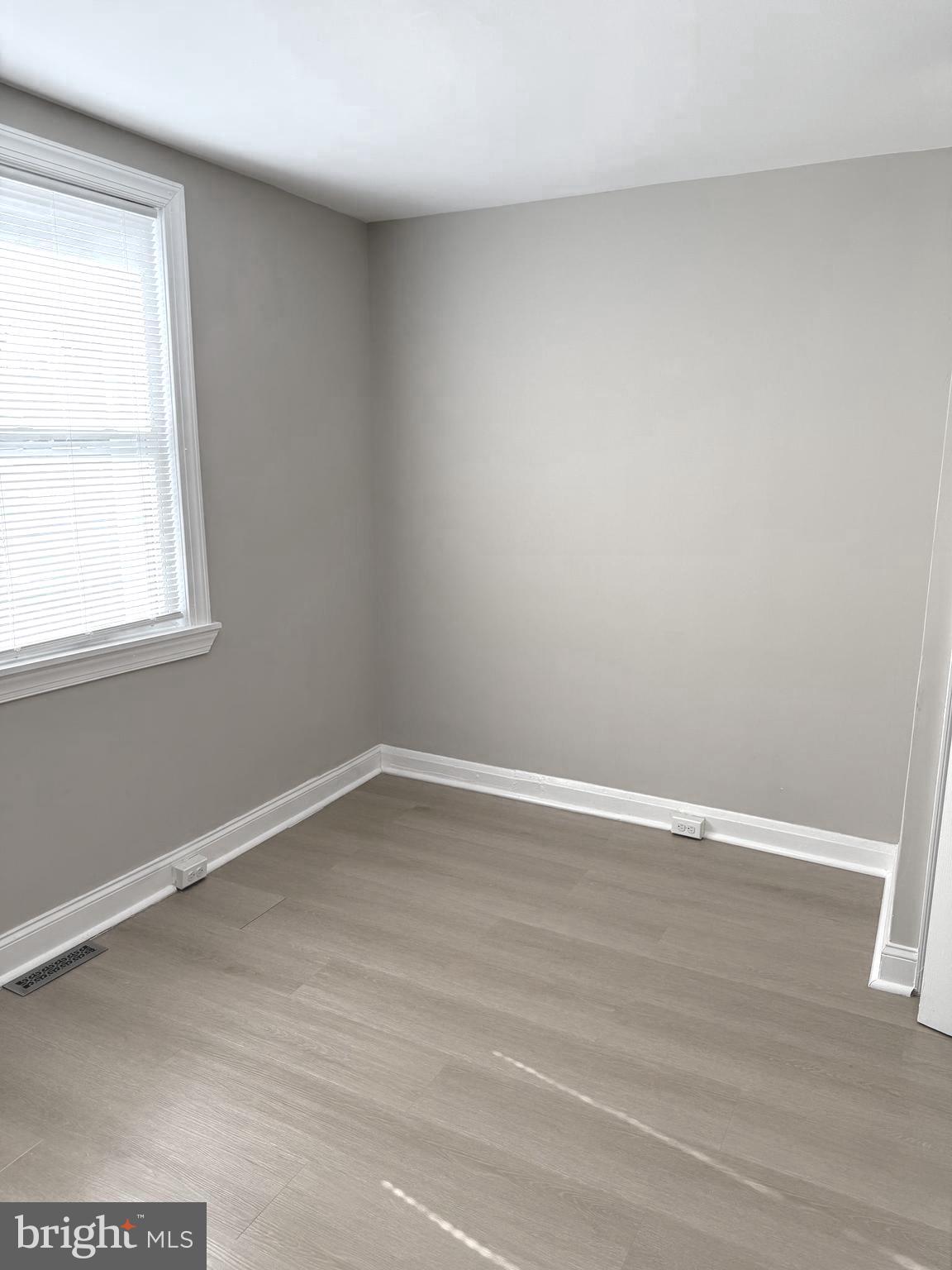 815 East Cold Spring Lane Baltimore, MD 21212 - Photo 23 of 43 wooden floor in an empty room with a window