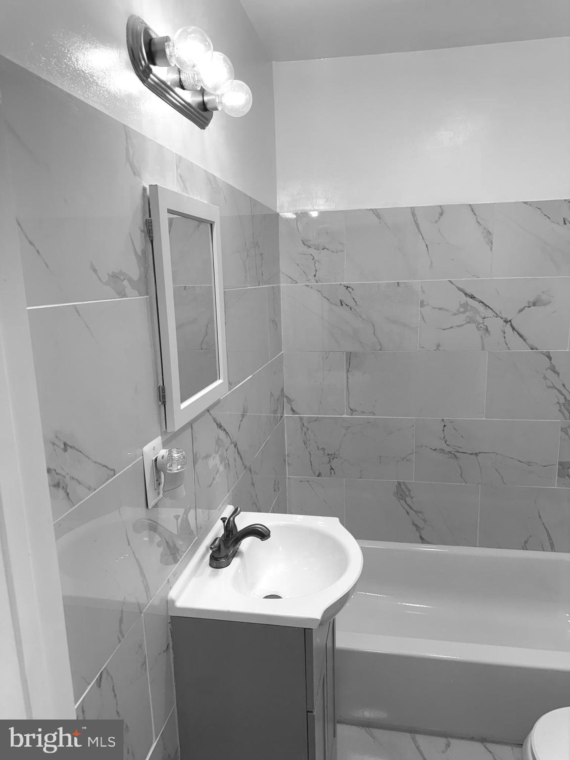 815 East Cold Spring Lane Baltimore, MD 21212 - Photo 33 of 43 a bathroom with a sink a toilet and shower