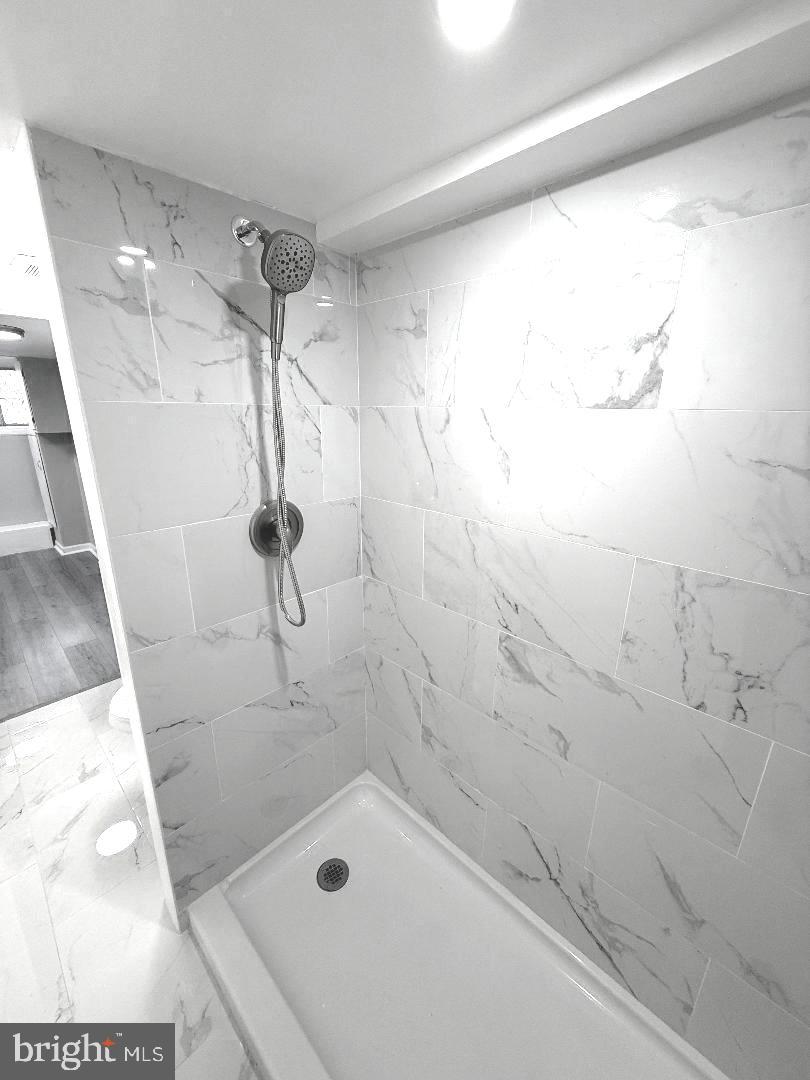 815 East Cold Spring Lane Baltimore, MD 21212 - Photo 37 of 43 a bathroom with a bathtub and a shower