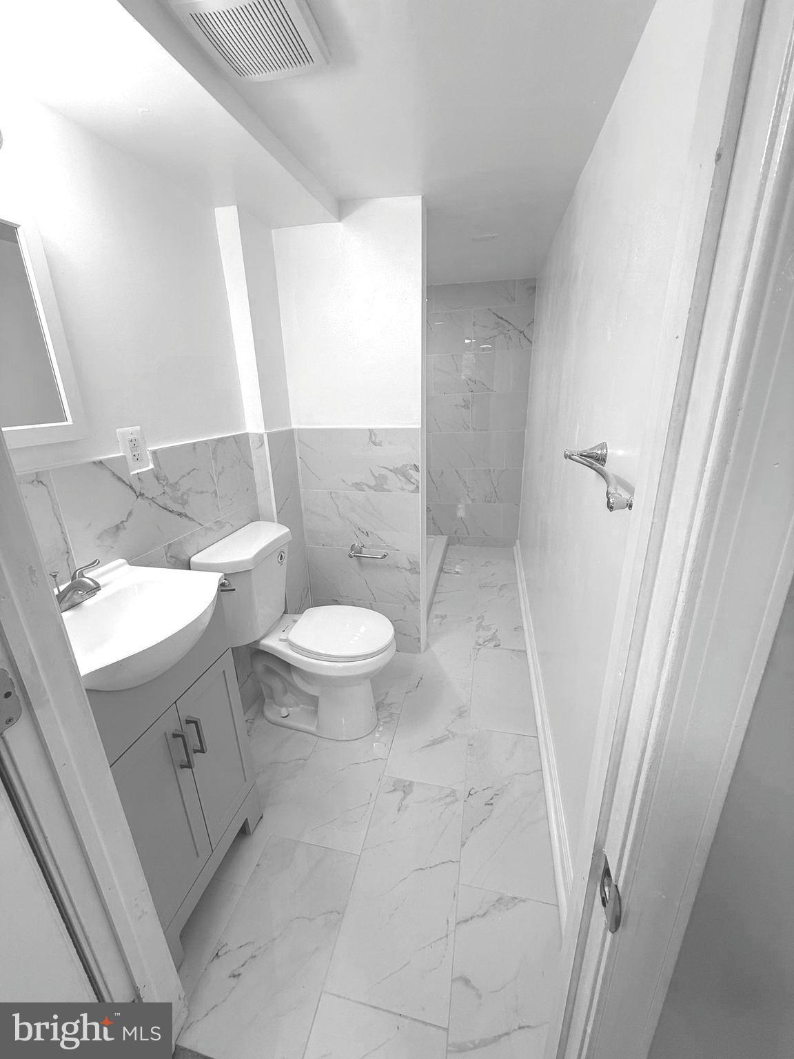 815 East Cold Spring Lane Baltimore, MD 21212 - Photo 38 of 43 a bathroom with a sink a toilet and a mirror