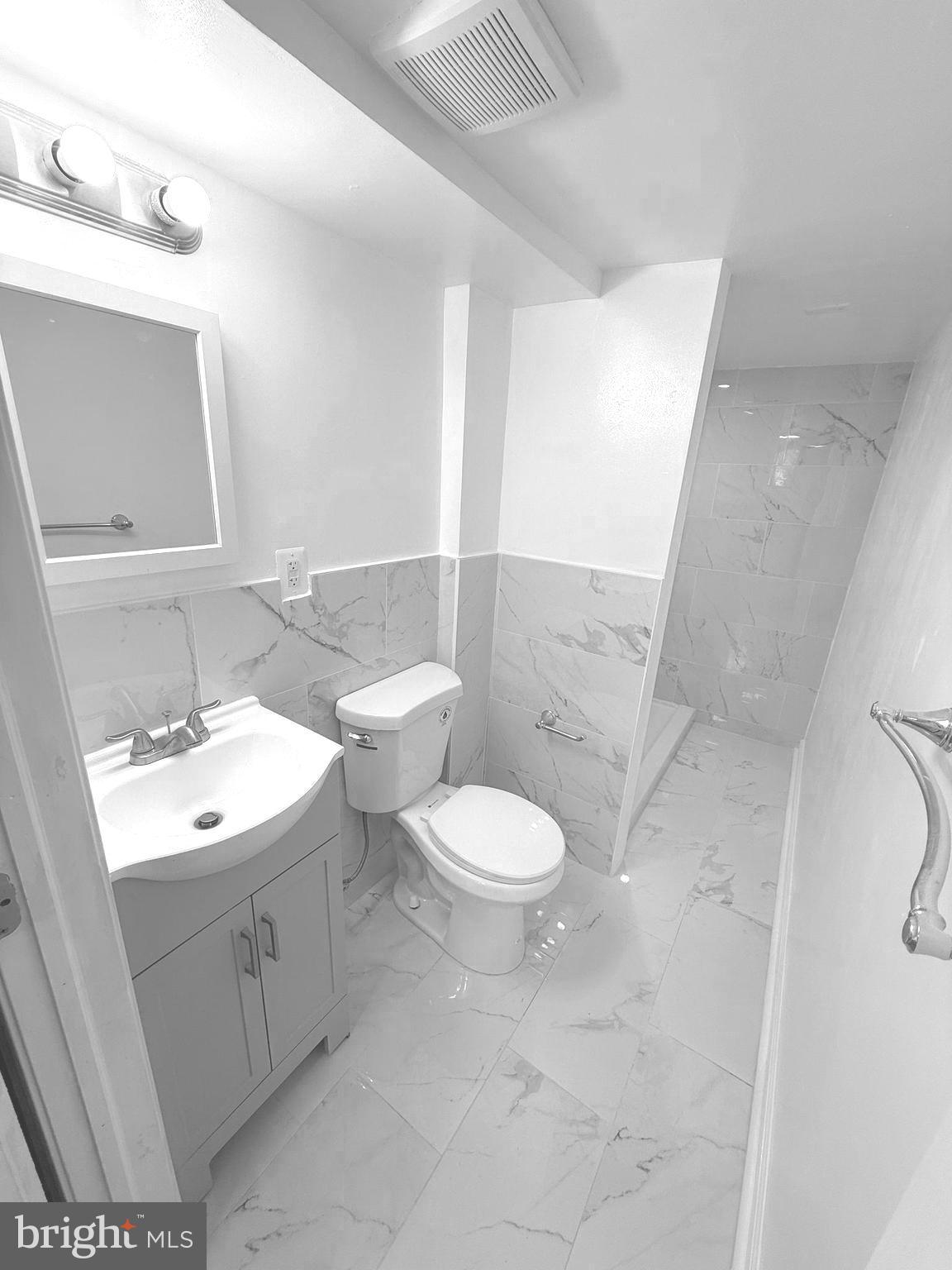 815 East Cold Spring Lane Baltimore, MD 21212 - Photo 39 of 43 a bathroom with a toilet sink and mirror