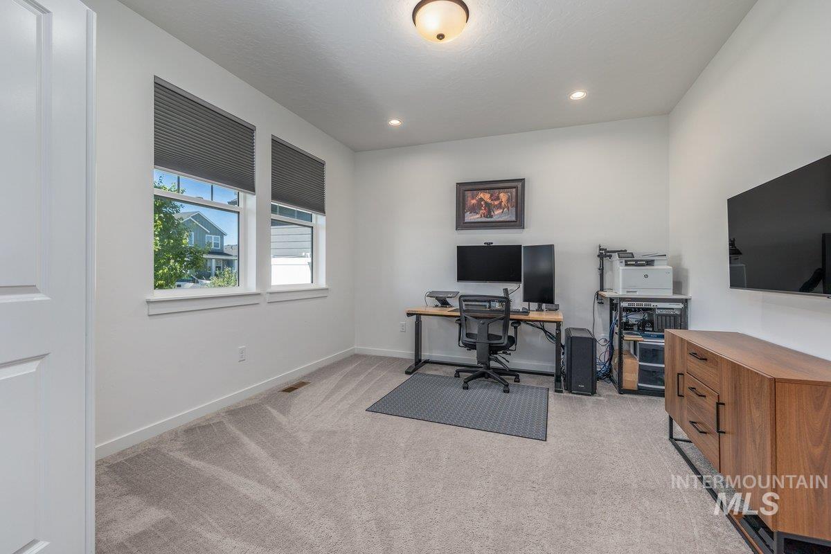 1380 West Chilitna Street Meridian, ID 83642 - Photo 37 of 50 Carpeted room featuring two windows with cellular shades, a built-in ceiling light fixture, recessed lighting, and white baseboards