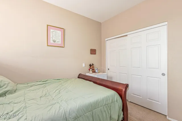 a bedroom with a bed and a painting on the wall