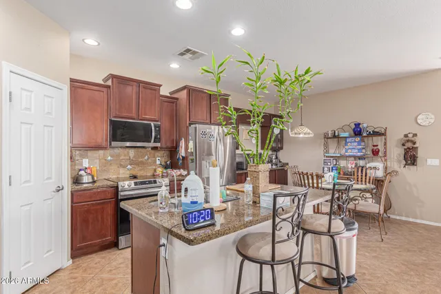 a view of a dining room and livingroom with furniture wooden floor a chandelier
