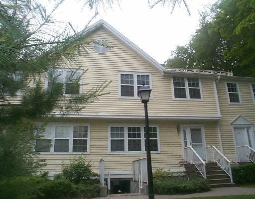 631 Danbury Road, Unit 30 Ridgefield, CT 06877 - Photo 1 of 1 a front view of a house with plants
