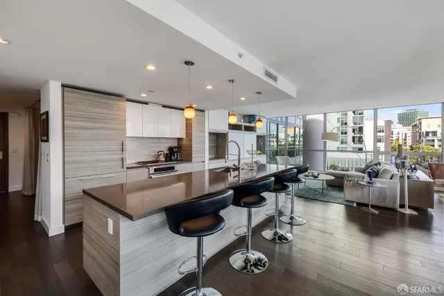 a kitchen with a table chairs stove and kitchen view