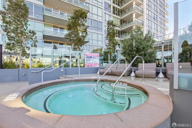 a view of roof deck with couches and sky view