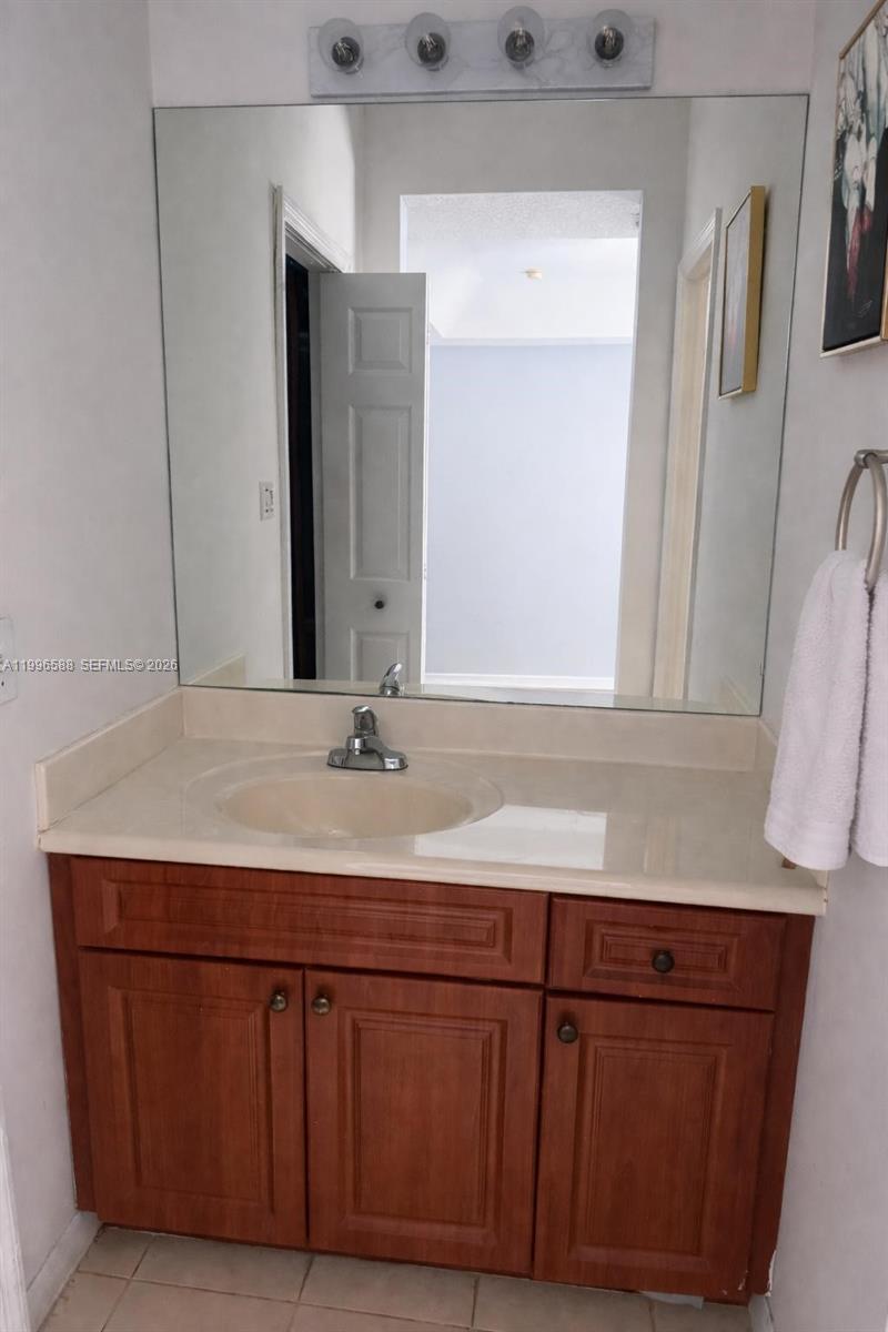 8441 Southwest 124th Avenue, Unit 106 Miami, FL 33183 - Photo 15 of 24 a bathroom with a sink and a mirror
