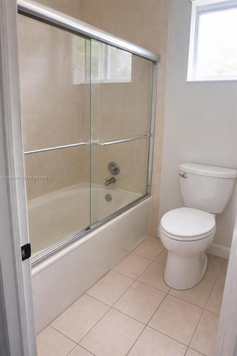 8441 Southwest 124th Avenue, Unit 106 Miami, FL 33183 - Photo 16 of 24 a bathroom with a toilet and a shower