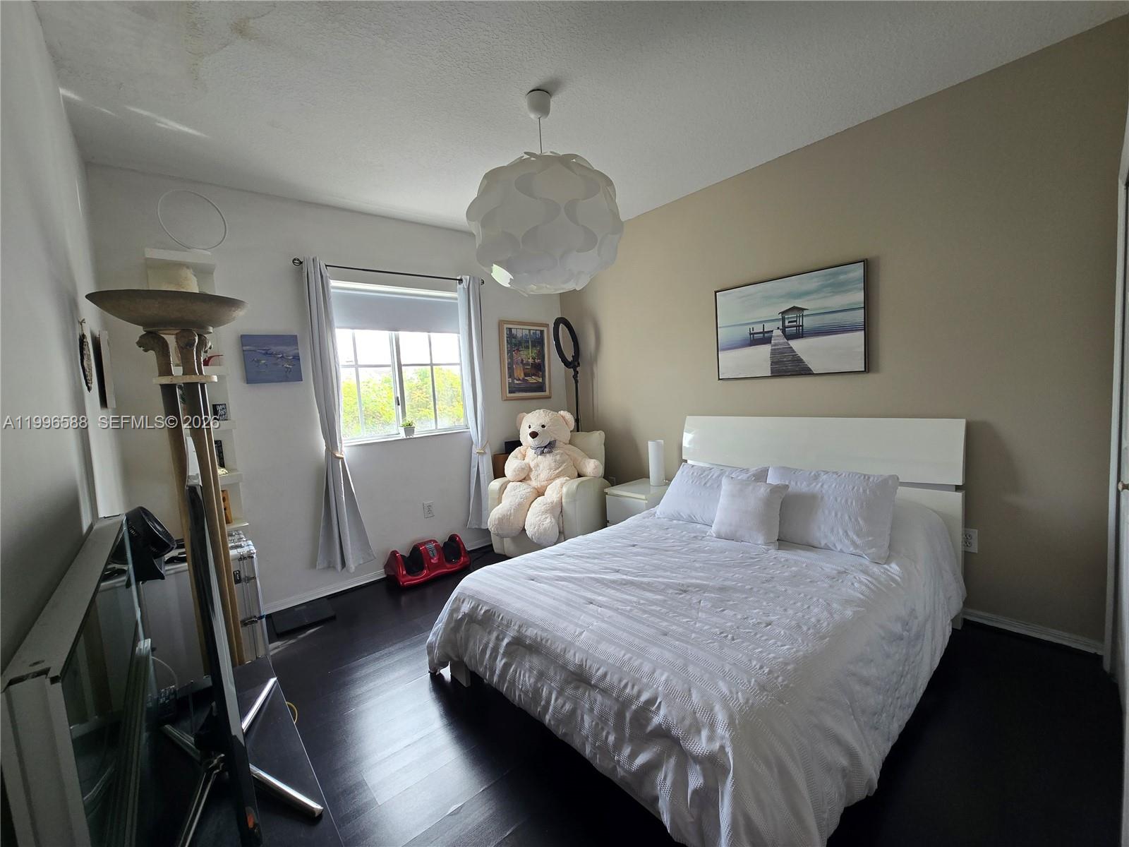 8441 Southwest 124th Avenue, Unit 106 Miami, FL 33183 - Photo 17 of 24 a bedroom with bed and a window