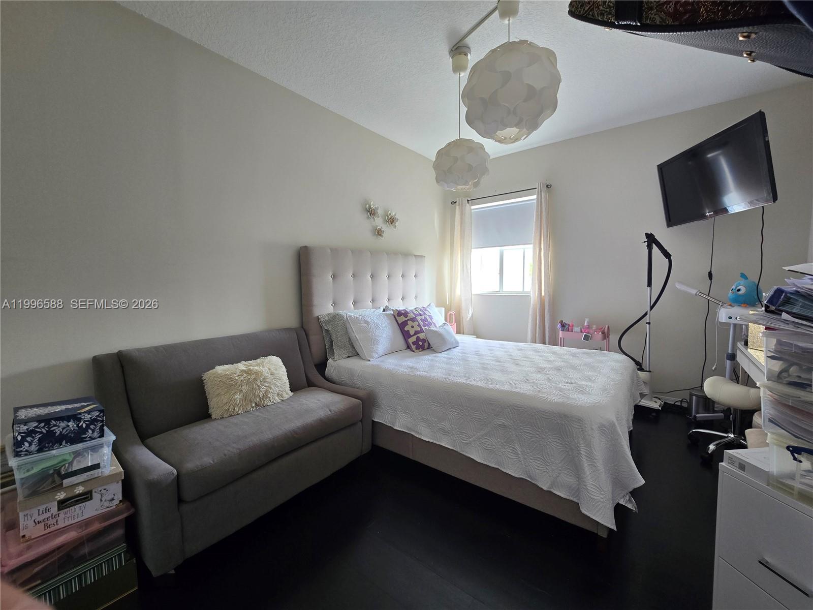 8441 Southwest 124th Avenue, Unit 106 Miami, FL 33183 - Photo 18 of 24 a bedroom with bed couch and window