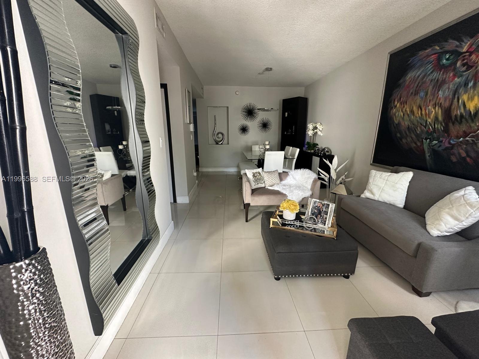 8441 Southwest 124th Avenue, Unit 106 Miami, FL 33183 - Photo 2 of 24 a living room with furniture and a couch