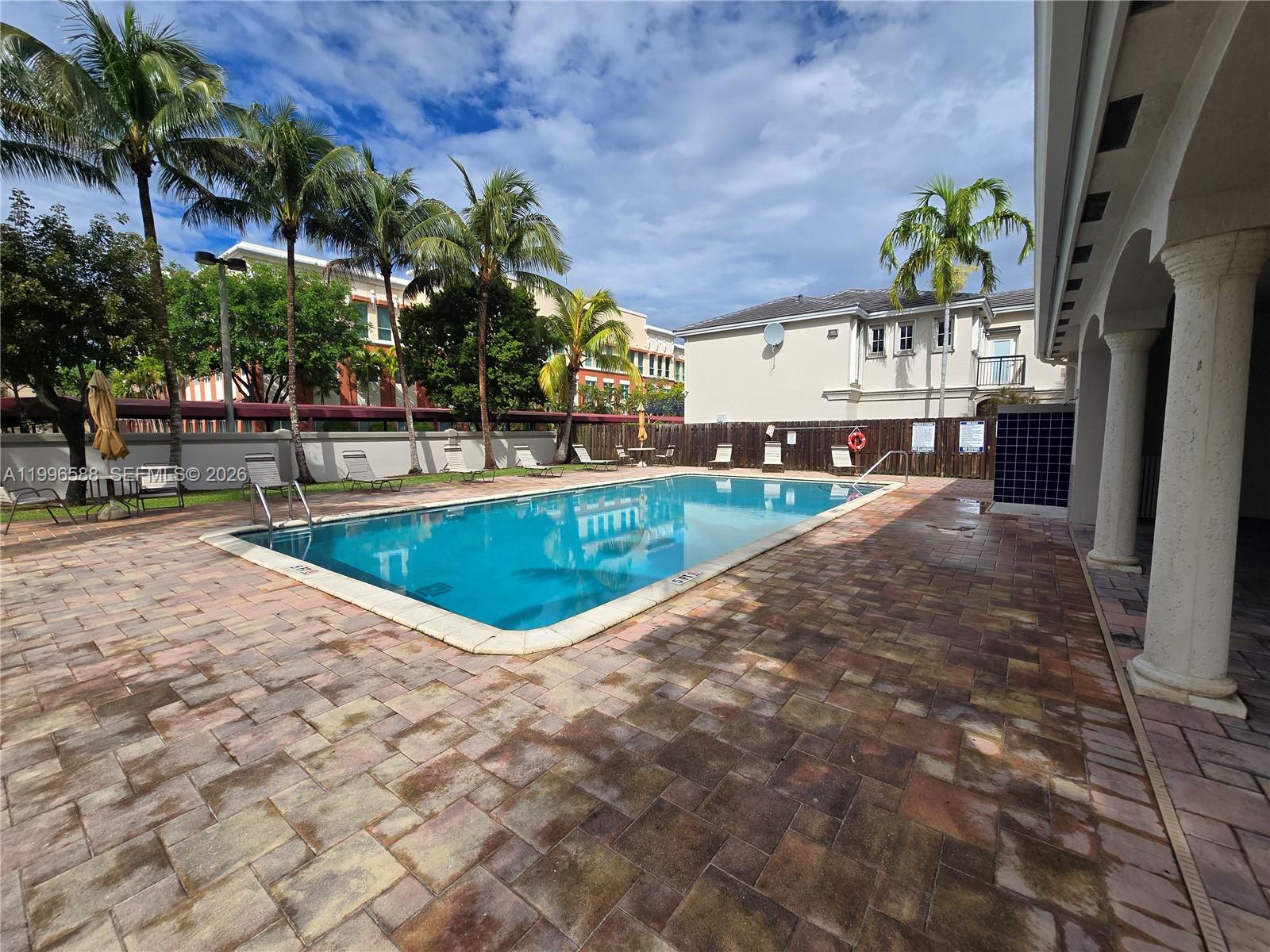 8441 Southwest 124th Avenue, Unit 106 Miami, FL 33183 - Photo 23 of 24 a view of a swimming pool with an outdoor space