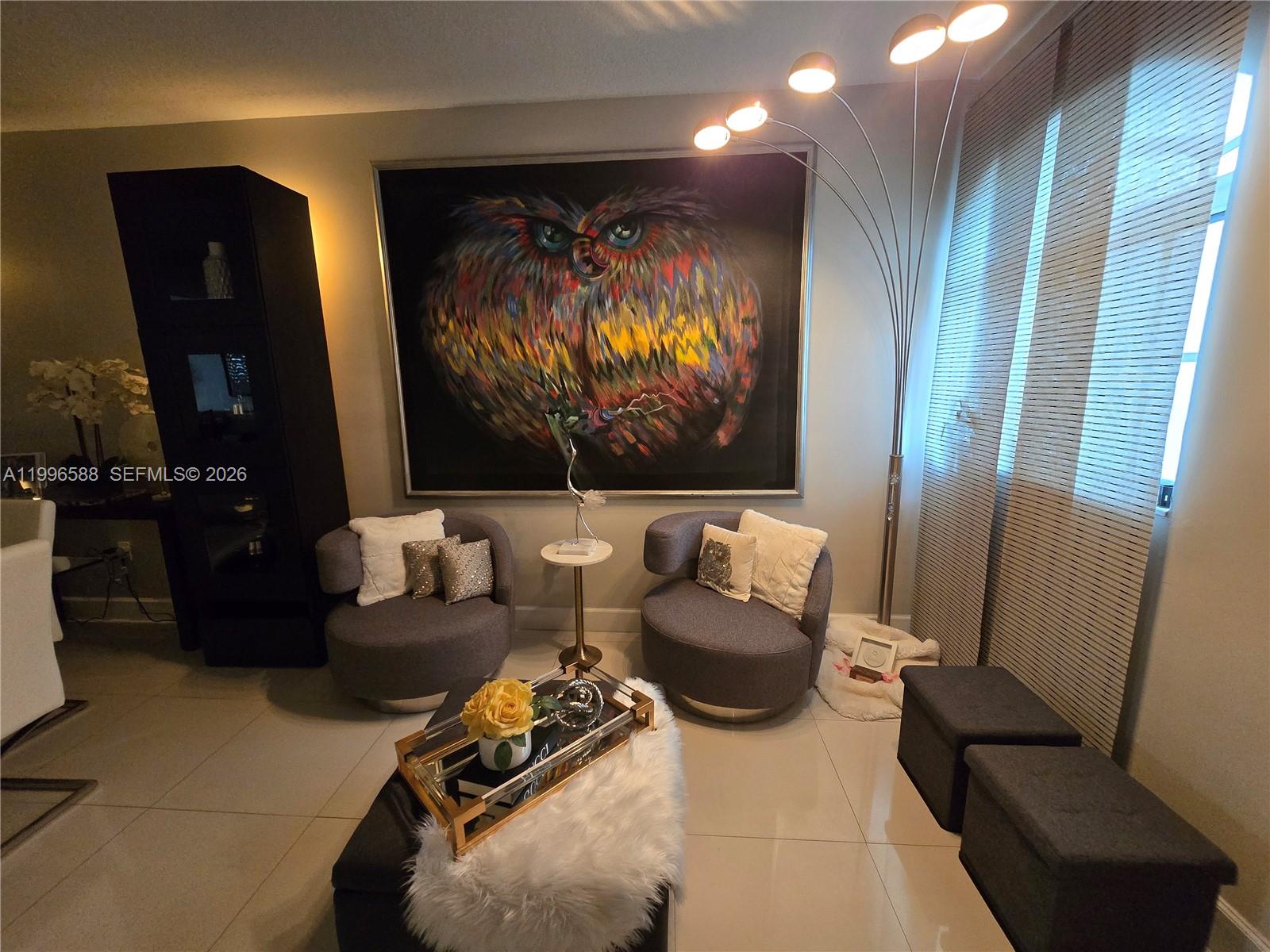 8441 Southwest 124th Avenue, Unit 106 Miami, FL 33183 - Photo 3 of 24 a living room with furniture and a flat screen tv