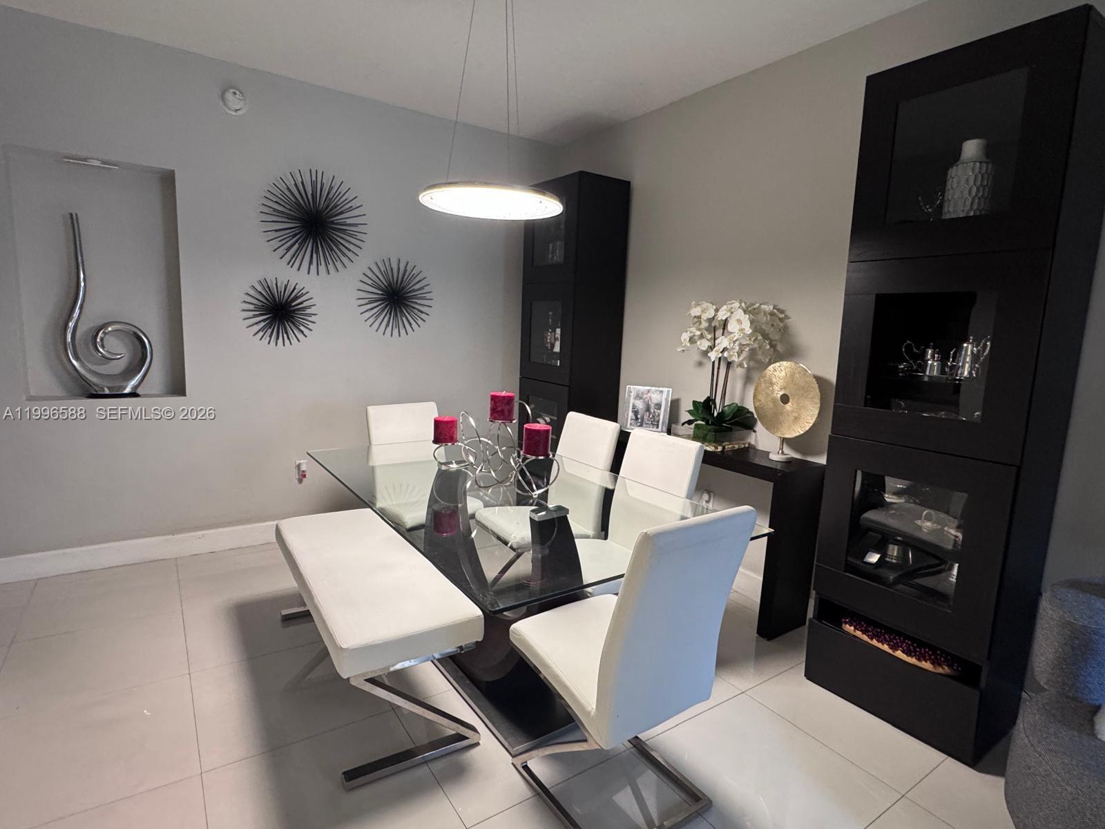 8441 Southwest 124th Avenue, Unit 106 Miami, FL 33183 - Photo 4 of 24 a living room with furniture and a fireplace