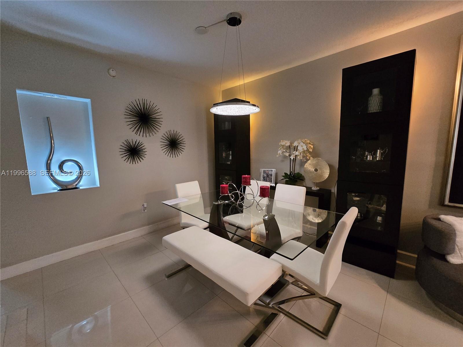 8441 Southwest 124th Avenue, Unit 106 Miami, FL 33183 - Photo 6 of 24 a dining room with a table and chairs