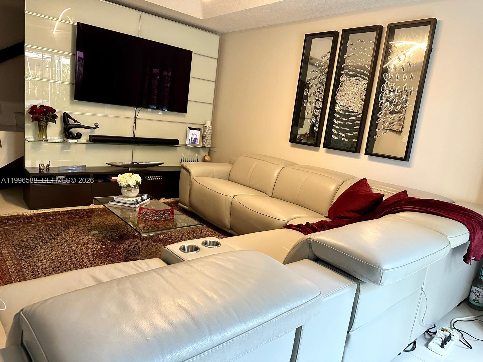 8441 Southwest 124th Avenue, Unit 106 Miami, FL 33183 - Photo 8 of 24 a living room with furniture and a flat screen tv