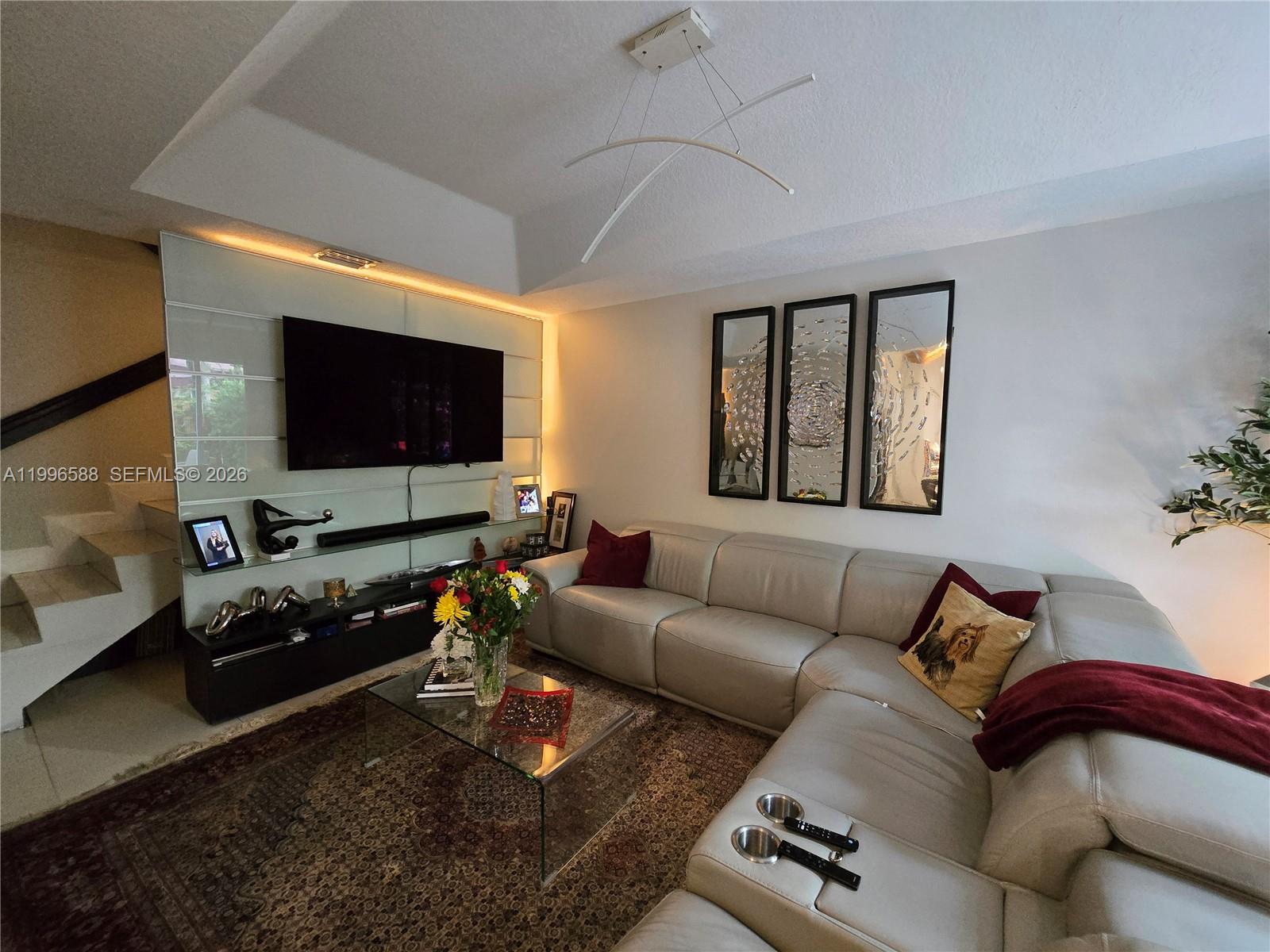 8441 Southwest 124th Avenue, Unit 106 Miami, FL 33183 - Photo 9 of 24 a living room with furniture and a flat screen tv