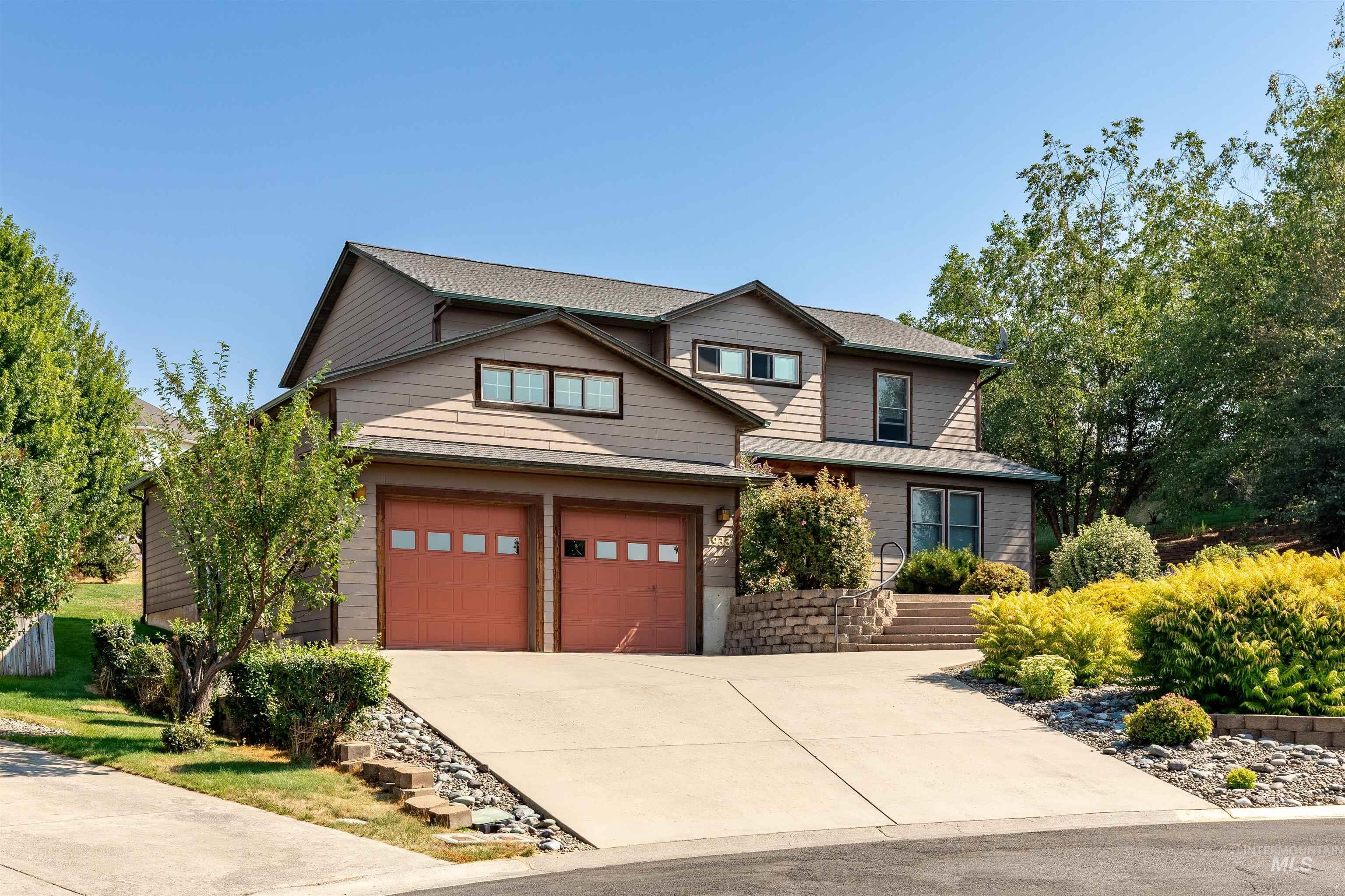 View of front of property featuring driveway and an attached garage