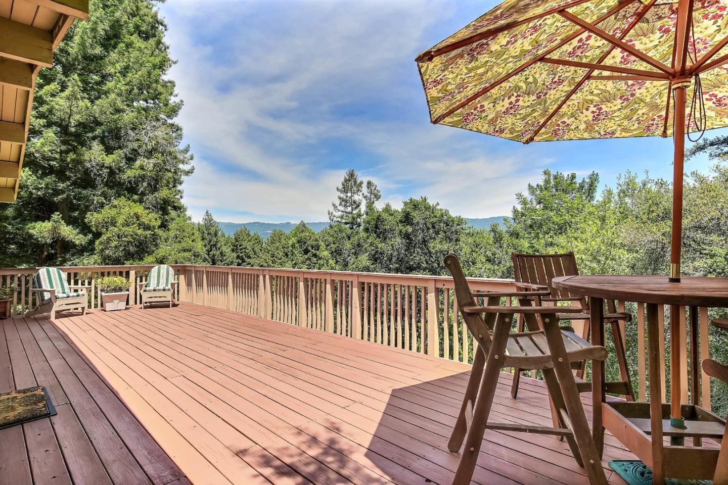 a balcony with wooden floor and city view