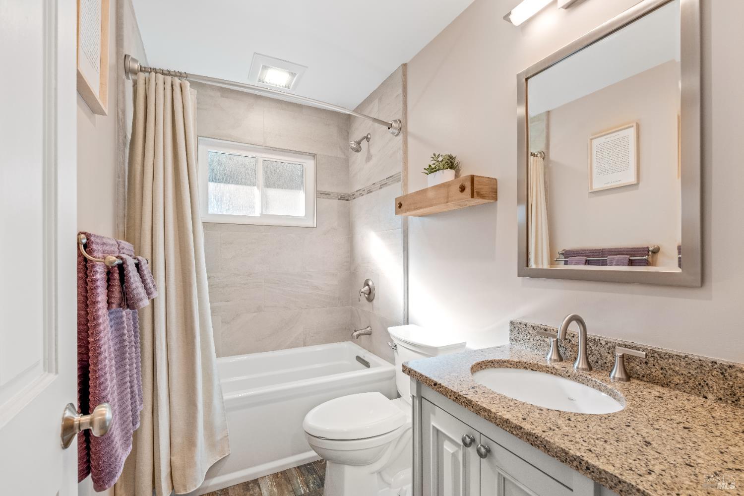 71 Convent Court San Rafael, CA 94901 - Photo 24 of 37 a bathroom with a granite countertop sink a toilet a mirror and shower