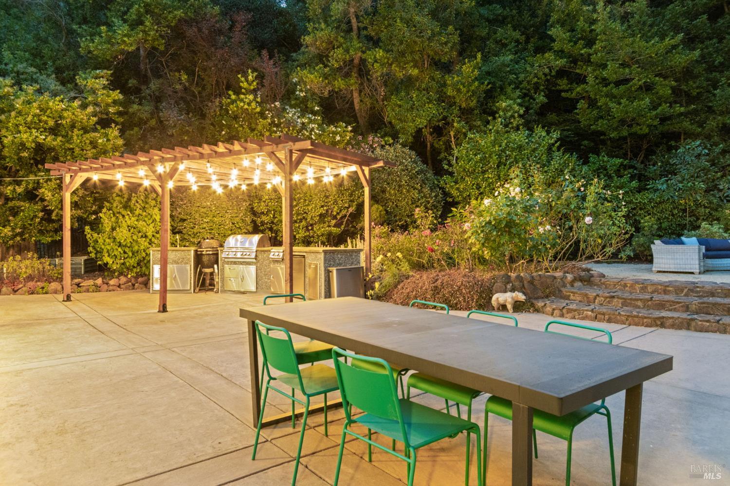 71 Convent Court San Rafael, CA 94901 - Photo 30 of 37 a view of a patio with table and chairs under an umbrella with large trees