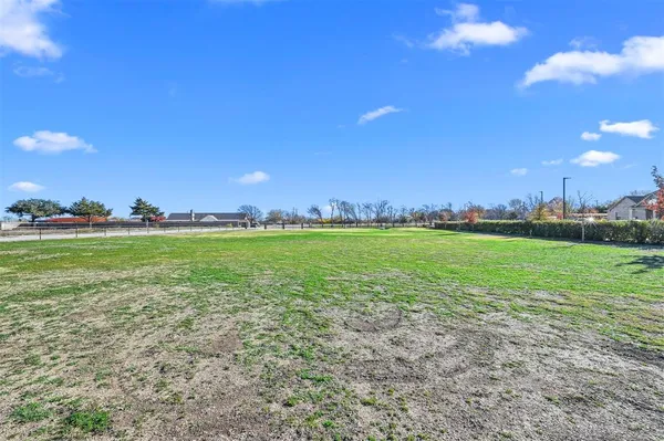 a view of yard with swimming pool and green space
