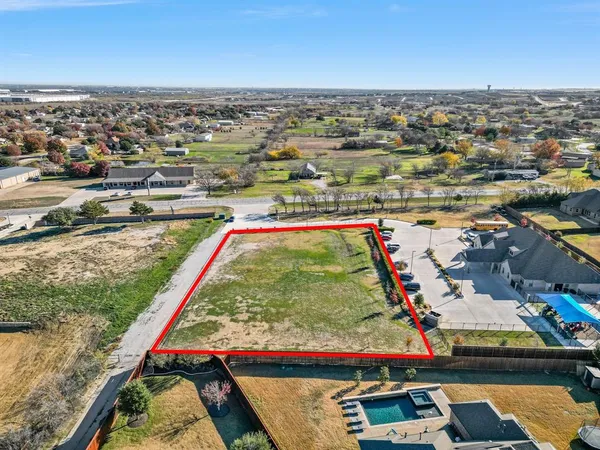 an aerial view of water body with boats and trees