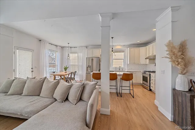 a large living room with furniture and a large window