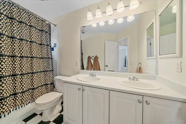 a bathroom with a sink toilet mirror and shower